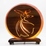3D Darwaish style Himalayan salt lamp with CNC cut design and wooden base glowing warm amber light